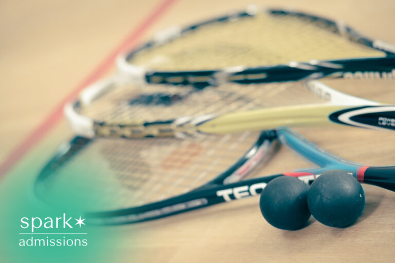 Squash rackets and balls arranged on an indoor squash court floor