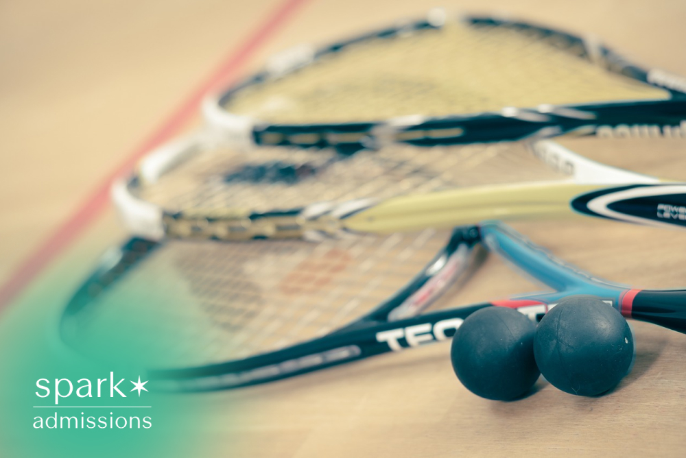 Squash rackets and balls arranged on an indoor squash court floor