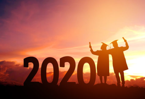 Two graduates next to large numbers saying '2020' backlit by a fiery sunset.