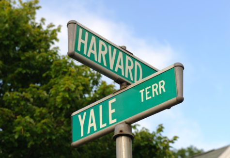 A street sign promoting 'Harvard' and 'Yale' terrace.