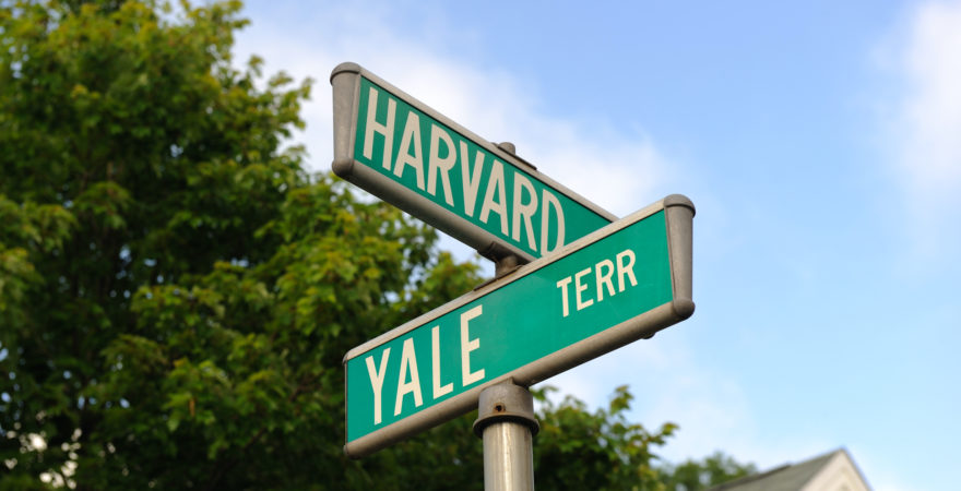 A street sign promoting 'Harvard' and 'Yale' terrace.