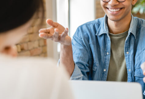 Student being interviewed, seated across from an interviewer