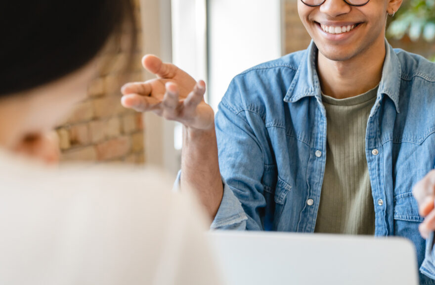 Student being interviewed, seated across from an interviewer