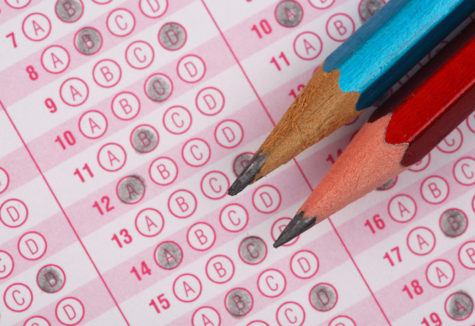 Two pencils resting on top of a completed scantron form.