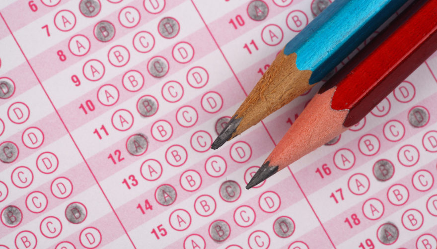 Two pencils resting on top of a completed scantron form.