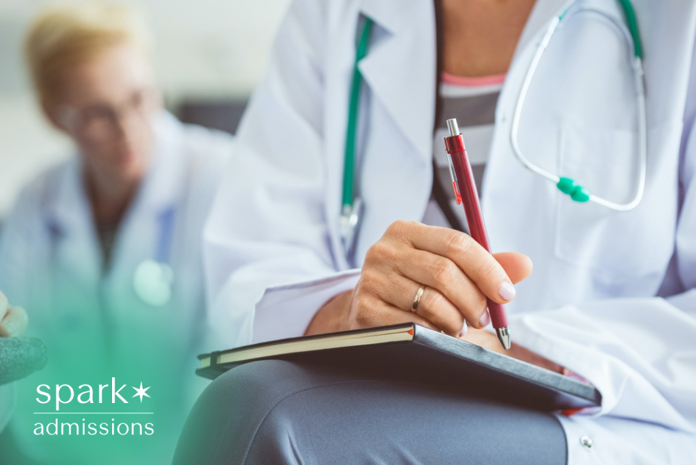 Behavioral health provider taking notes during a patient consultation in a clinical setting.