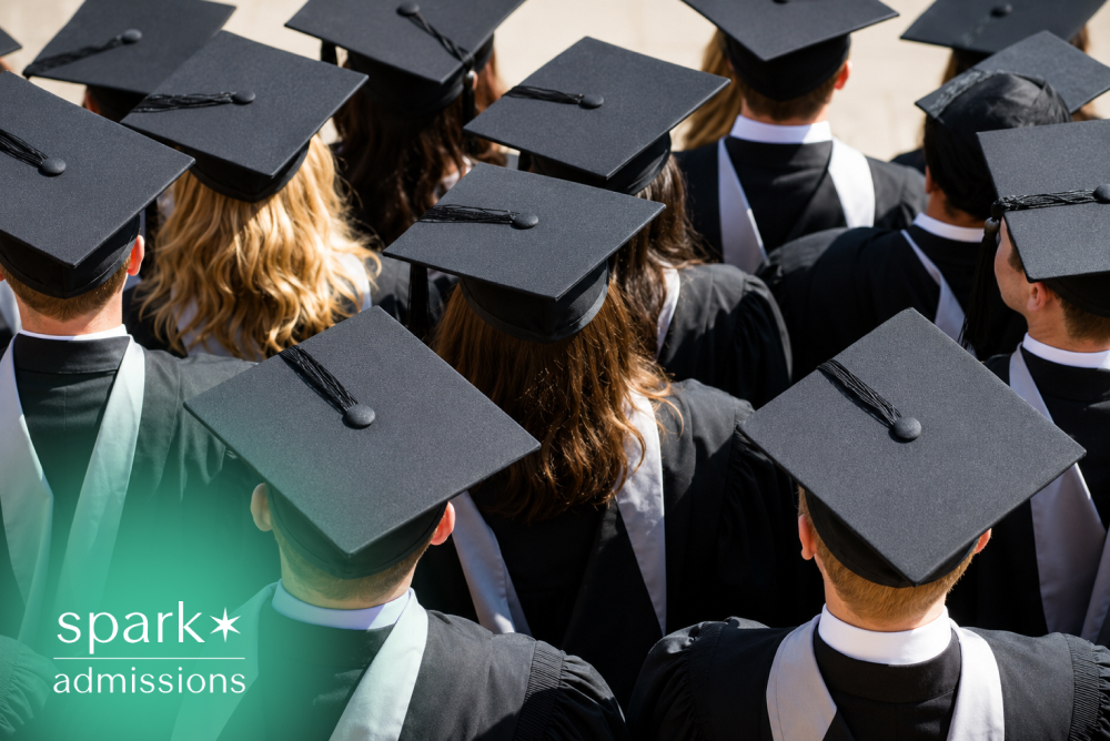 Rear view of a diverse group of college graduates wearing caps and gowns during a graduation ceremony, celebrating academic achievement and university commencement.