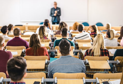 Students sitting in a lecture hall during a university class.