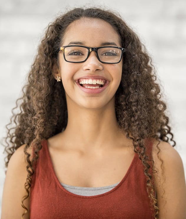 Smiling black high school girl wearing glasses