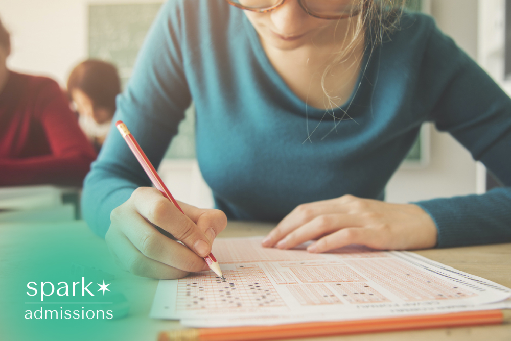 Student completing a standardized test by filling in answers on a multiple-choice exam sheet.