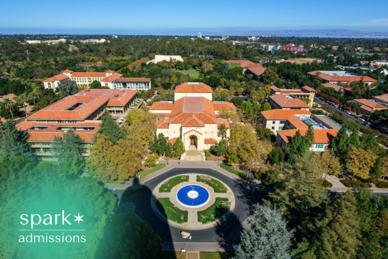 Aerial view of a university campus with academic buildings, trees, and a central fountain.
