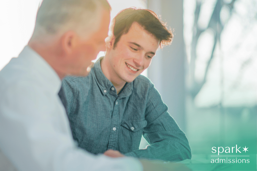 Student smiling while guided by academic mentor
