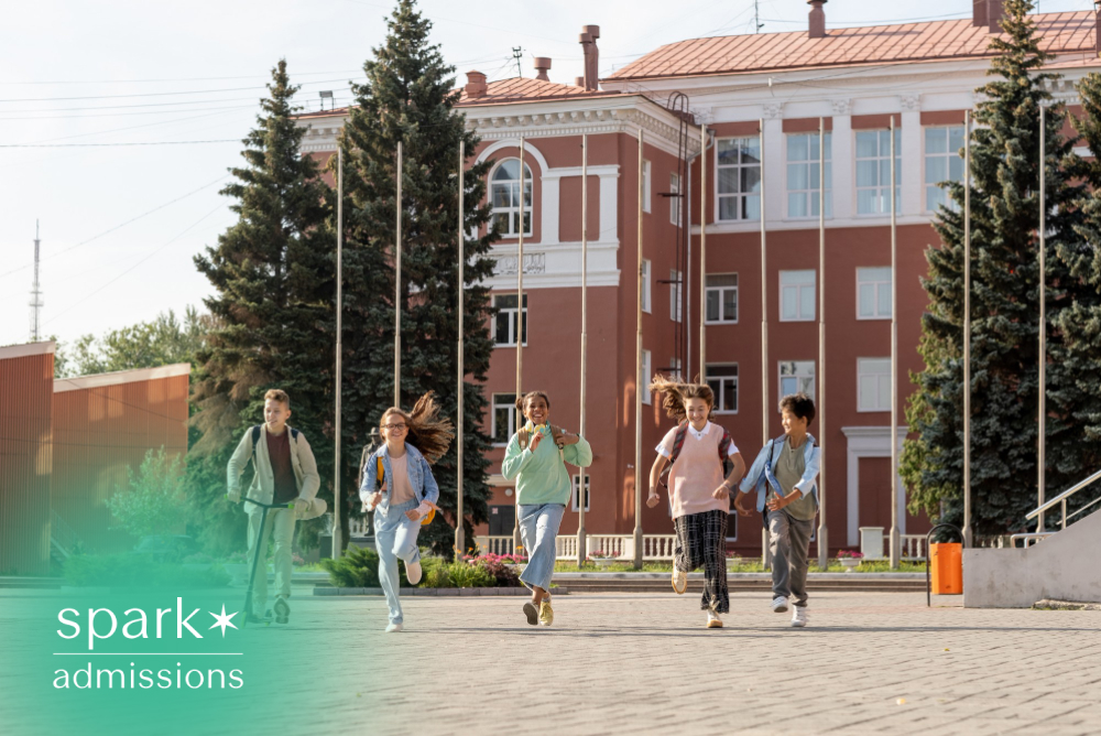 Diverse group of students running across a school campus with backpacks on a sunny day in front of an academic building, showcasing an energetic and welcoming campus environment.