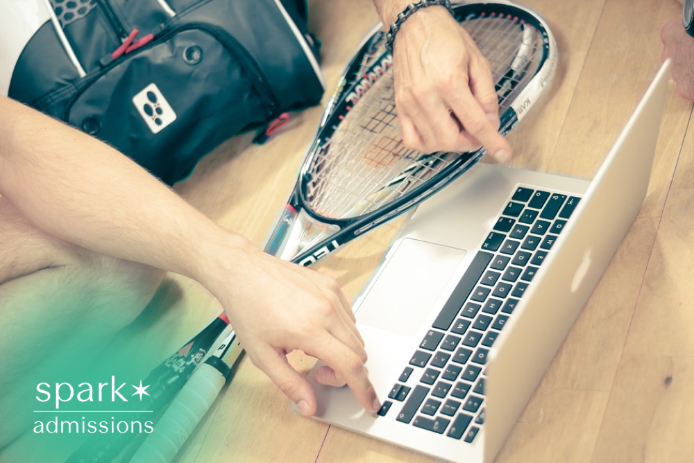 Student athlete using a laptop to review college recruitment information with tennis rackets and sports gear nearby.