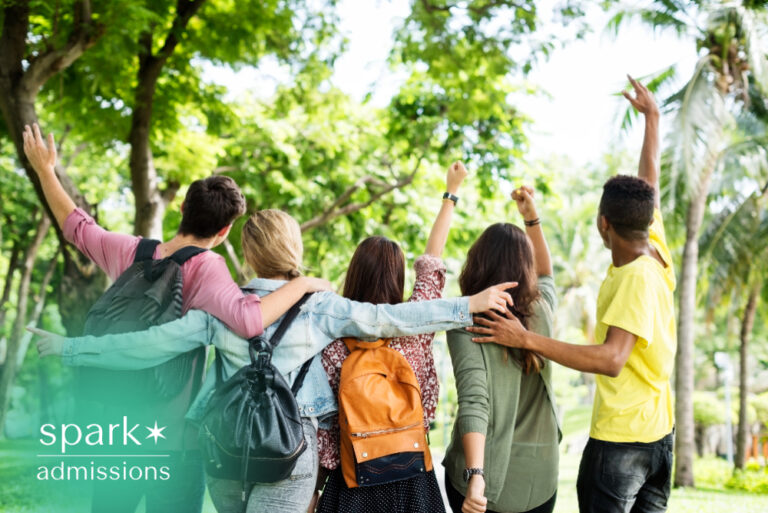 Diverse students walking together on campus with backpacks