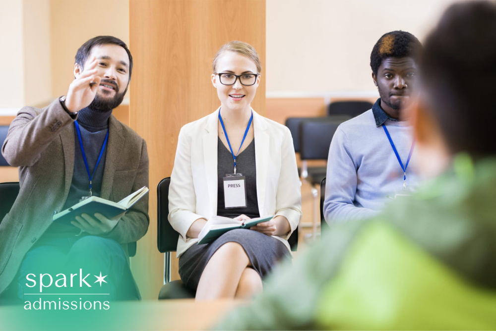 Admissions panel interviewing a student during a college meeting`