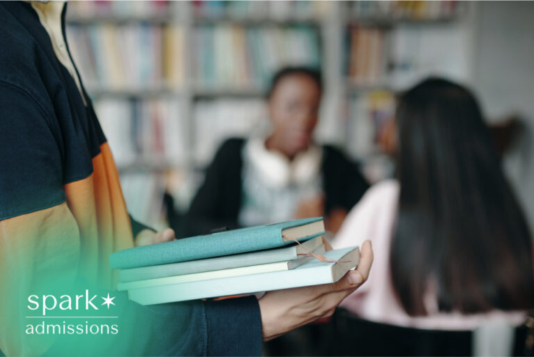 student-holding-books-in-library