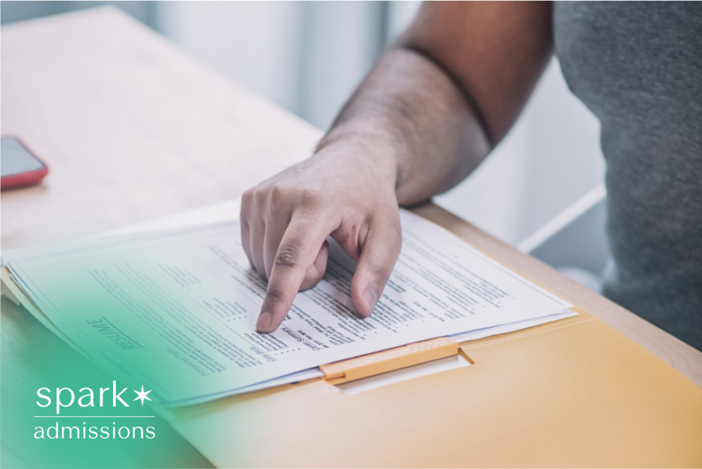 Student reviewing resume and application documents on a desk