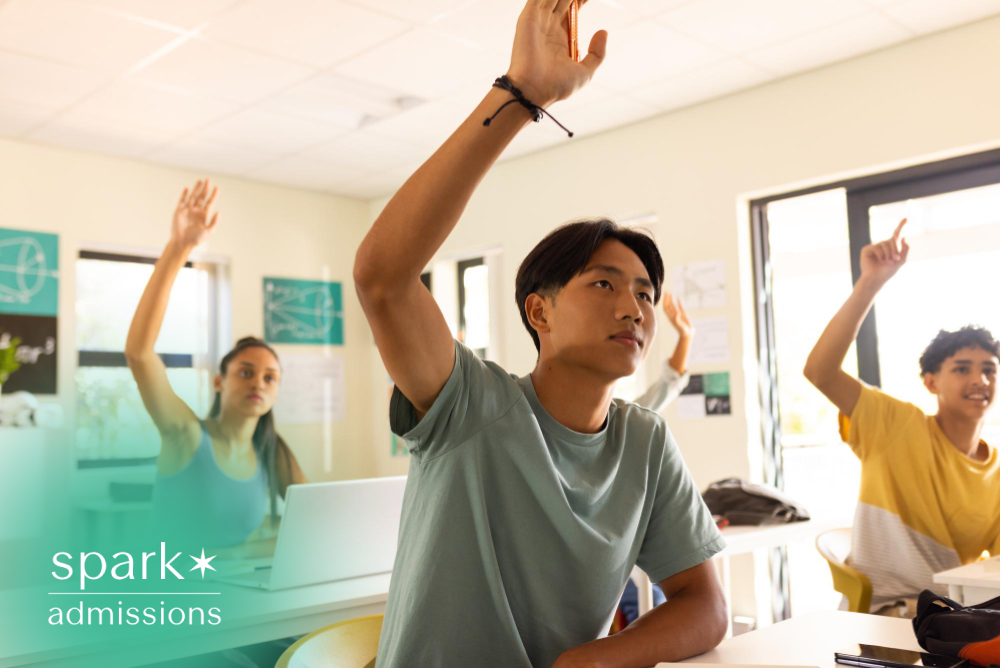 Students raising hands during a classroom discussion