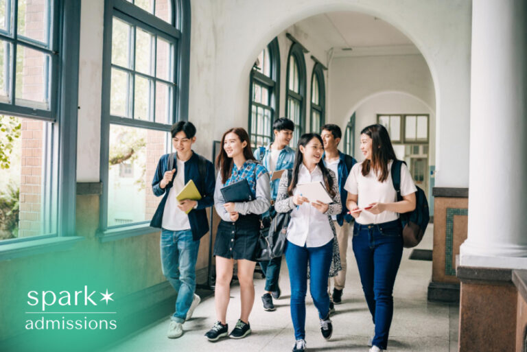 Students walking together in a university hallway with notebooks