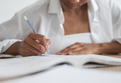 woman writing on a table