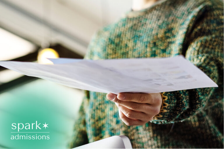 Student holding admissions paperwork for review