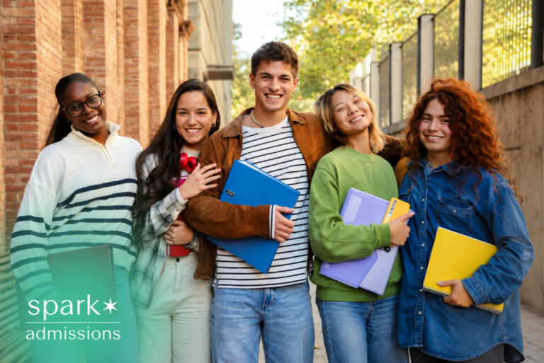 Diverse students smiling together on campus with folders
