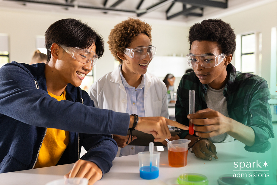 In high school, teenagers conducting science experiment with test tubes in classroom