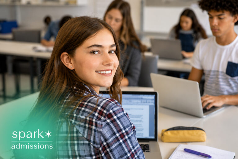 Student using laptop in classroom for college admissions prep