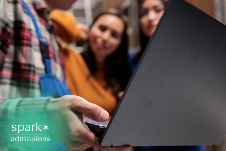 Students reviewing a laptop together during a college study session