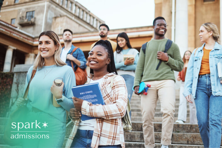 Diverse college students walking down campus steps with books