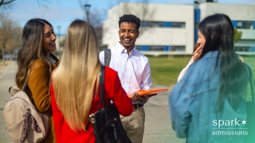 Group of college students talking together outdoors on campus.