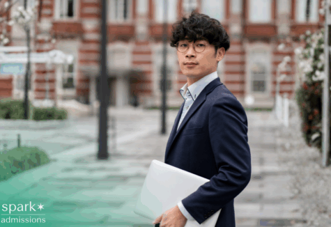 Asian male business college student holding a laptop