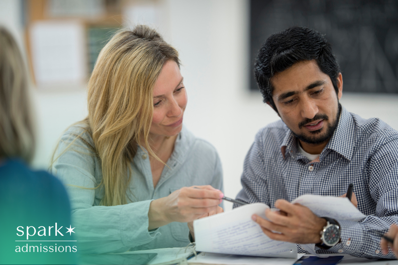 College admissions staff reviewing student documents for transfer evaluation.