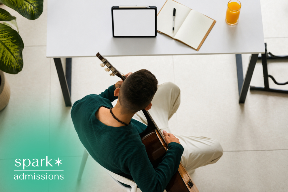 Student practicing guitar during an online music lesson