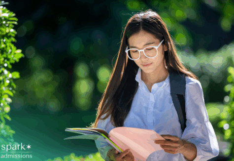 College student reviewing transfer credit documents in hand