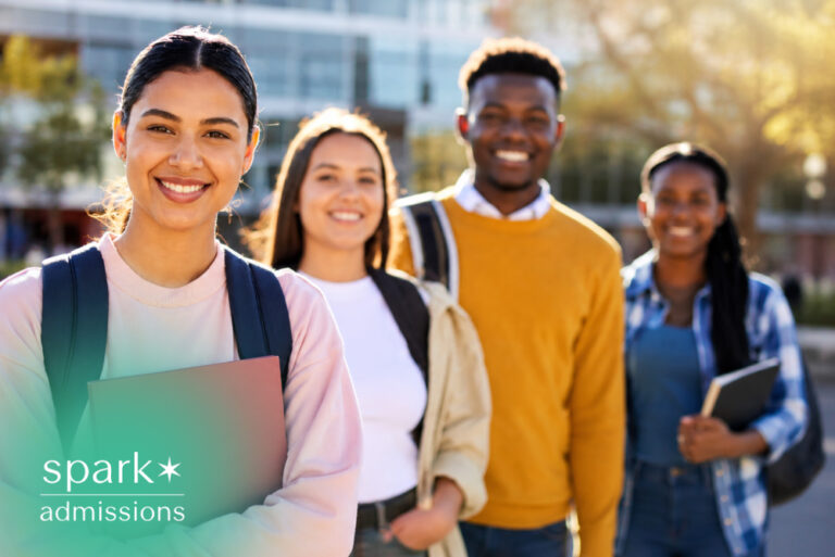 Diverse group of college students smiling on campus with books and backpacks