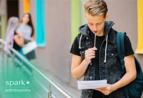 Student reviewing notes while planning college applications on campus