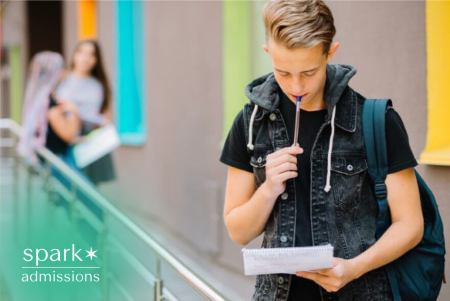 Student reviewing notes while planning college applications on campus