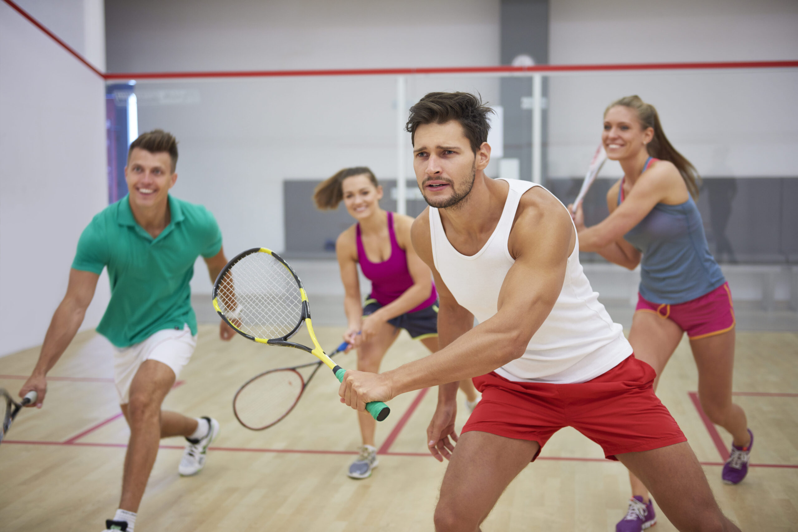 Squash player smiling and giving a high five after a match