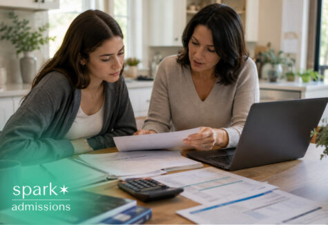 Parent reviewing college costs with teen at kitchen table