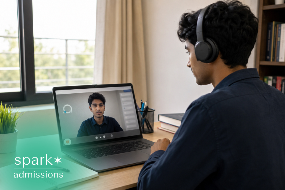 Student wearing headphones during an online video class with laptop and notebook at desk