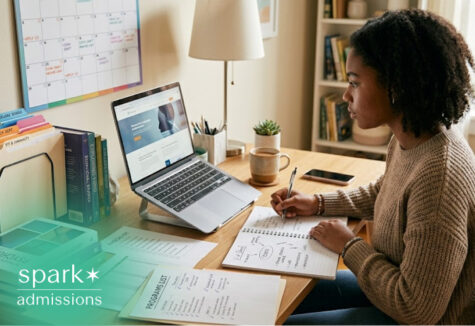 Student planning college applications with laptop and program list