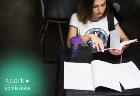 Student reviewing class notes and study materials at a desk