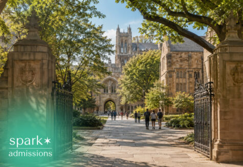 Ivy League campus gate opening to a tree-lined walkway and historic buildings