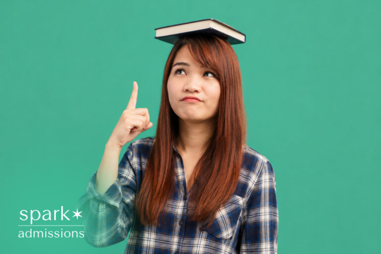 Student balancing a book on her head while thinking about education.