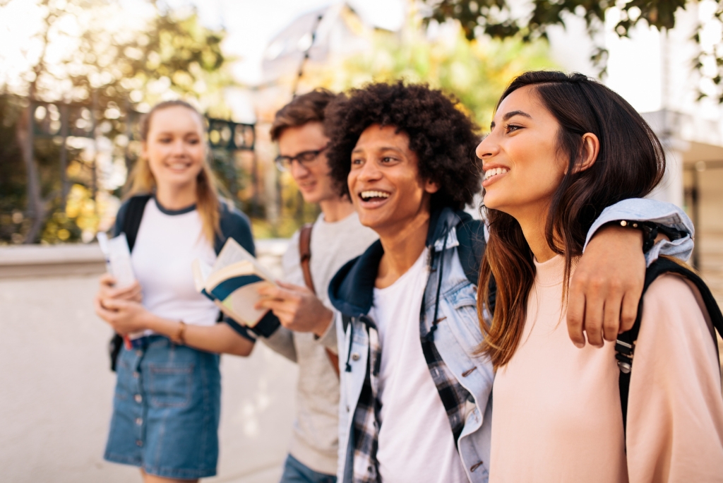 Group of college students walking together on campus