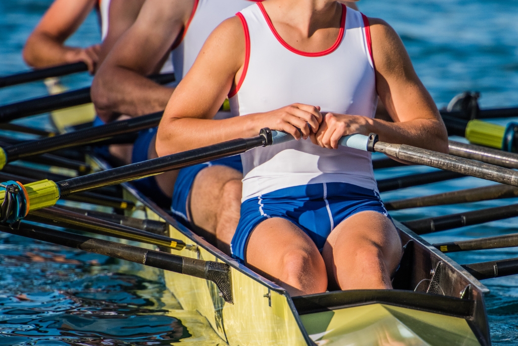College rowing athletes competing on the water, representing the college rowing recruiting process.