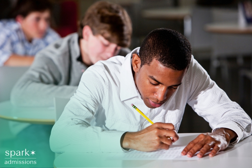 High school student completing an academic exam as part of college admissions preparation.