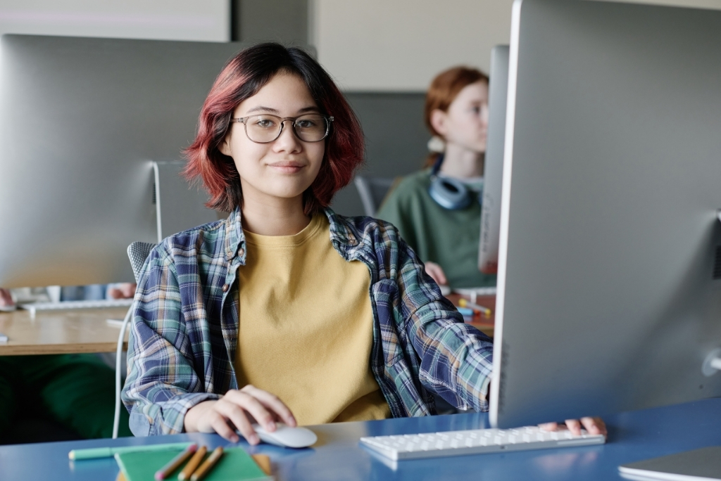 Student working at a computer in a school lab, representing undergraduate computer science admissions.